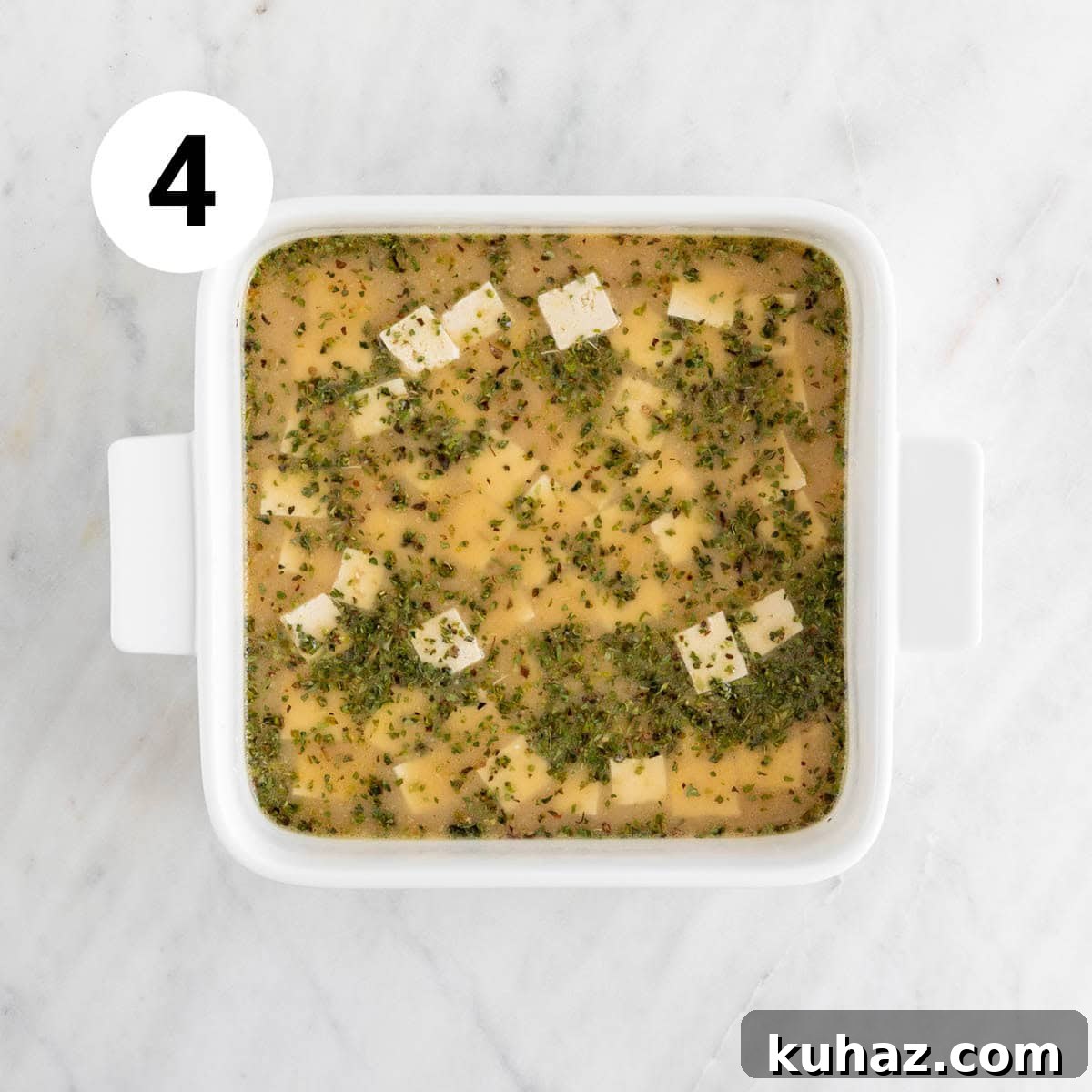 Homemade Vegan Feta Cheese Recipe 7 Tofu cubes marinating in baking dish.