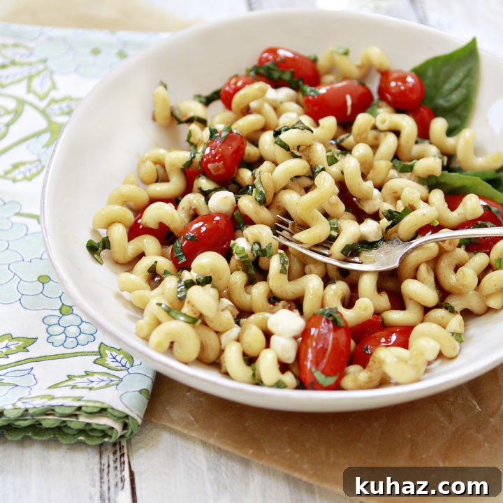 photo of caprese pasta in a white bowl
