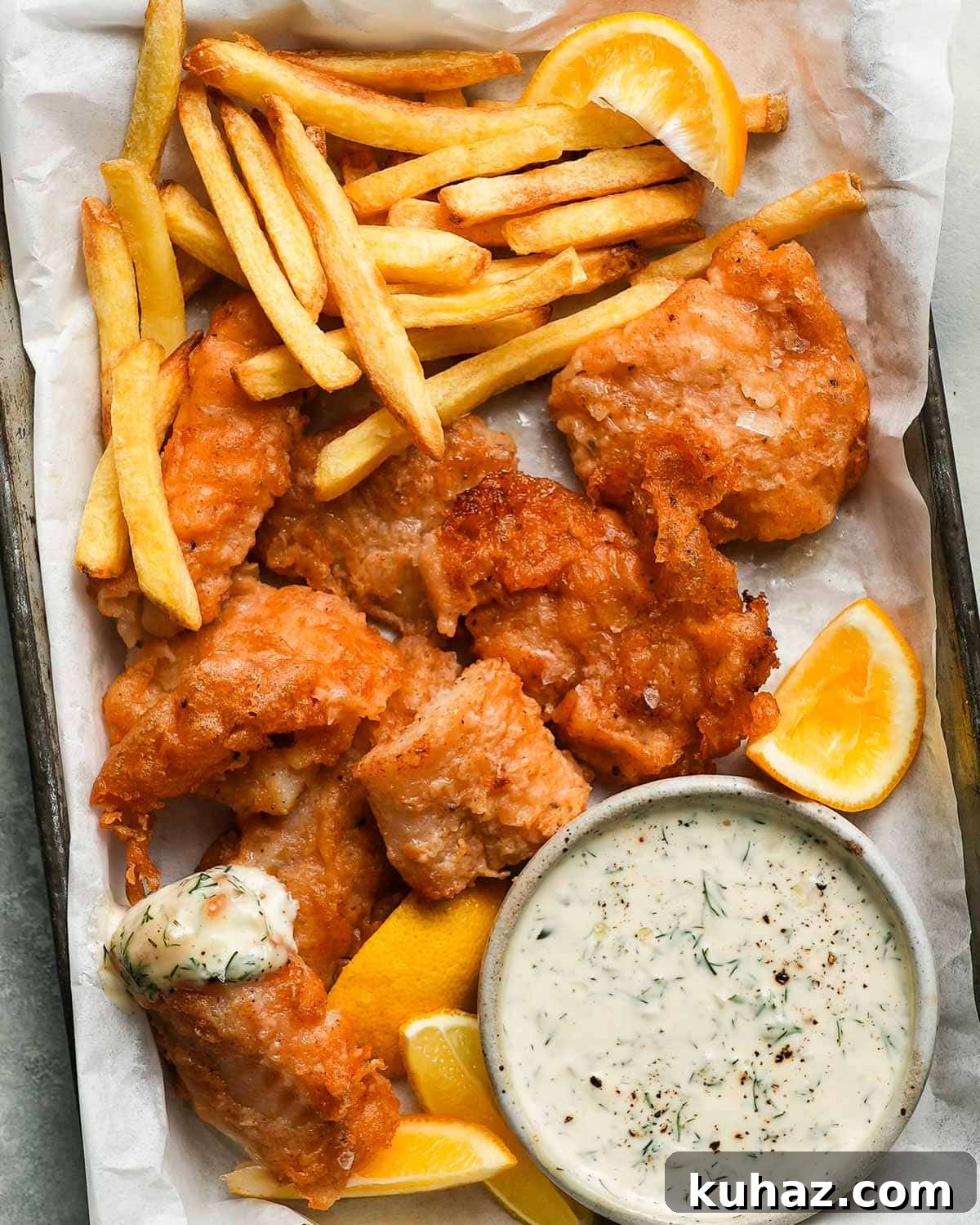 14 Crowd-Pleasing Game Day Appetizers 11 Fried cod with fries, lemon wedges, and tartar sauce on a tray.
