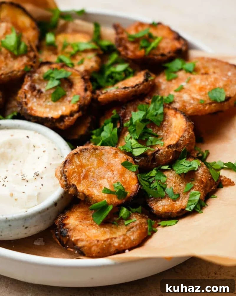 14 Crowd-Pleasing Game Day Appetizers 6 A plate of fried pickles topped with fresh herbs and a mayo dip.