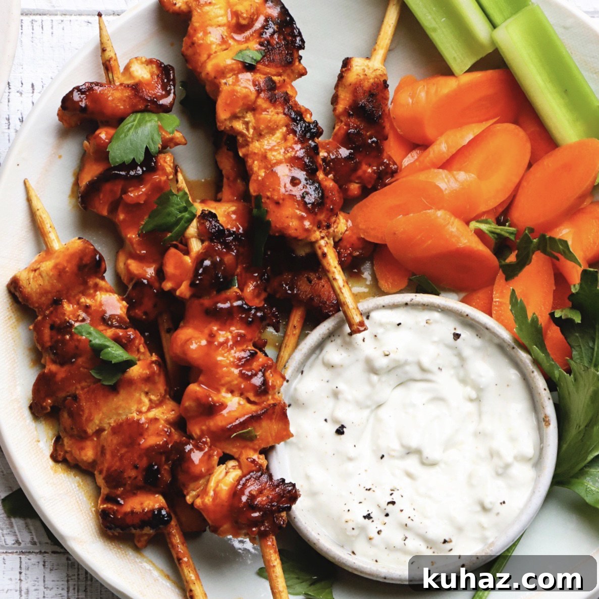 14 Crowd-Pleasing Game Day Appetizers 10 Buffalo chicken skewers with carrot slices, celery, and a bowl of ranch dip.