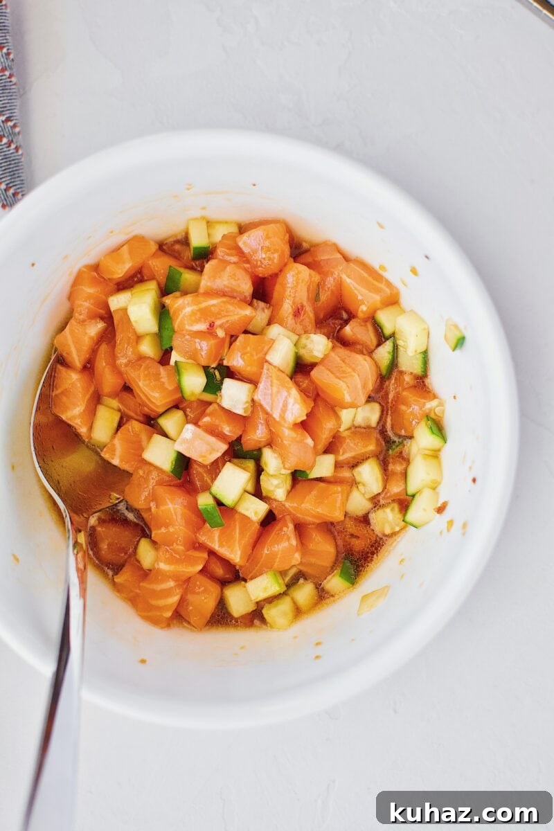 Ahi Tuna Tower with Avocado and Mango 11 Salmon, cucumber, and poke marinade in a bowl