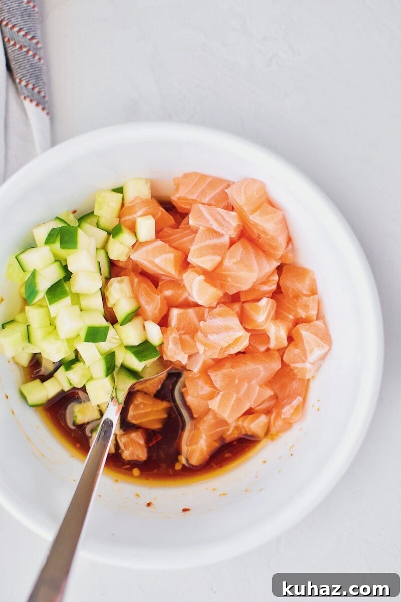 Ahi Tuna Tower with Avocado and Mango 9 Salmon, cucumber, and poke marinade in a bowl