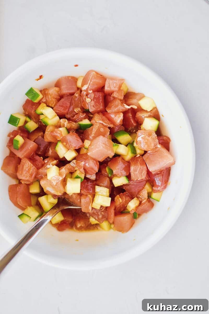 Ahi Tuna Tower with Avocado and Mango 10 Tuna, cucumber, and poke marinade in a bowl