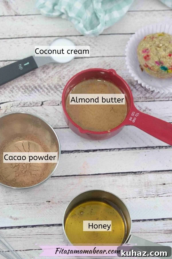 Ingredients like cacao powder, nut butter, and coconut cream in measuring cups.