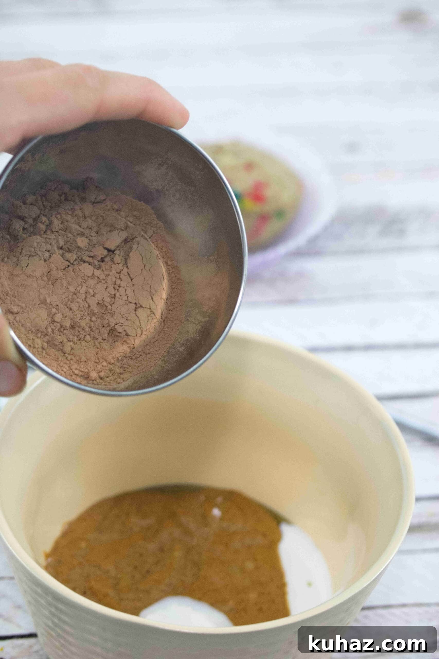 Cacao powder being added to a bowl.