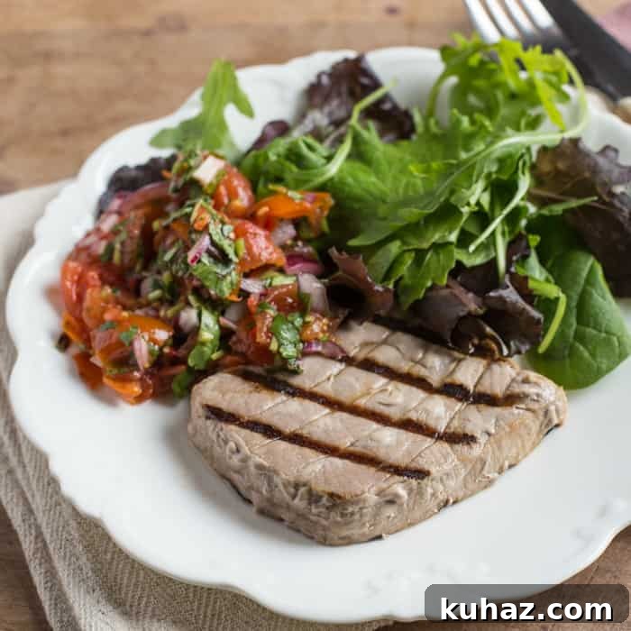 White plate with griddled tuna and salad