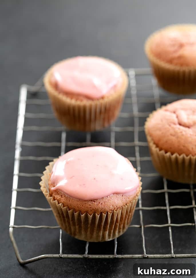 Gluten Free Strawberry Cupcakes with Fresh Strawberry Frosting 3 Strawberry cupcakes glazed and unglazed on wire rack