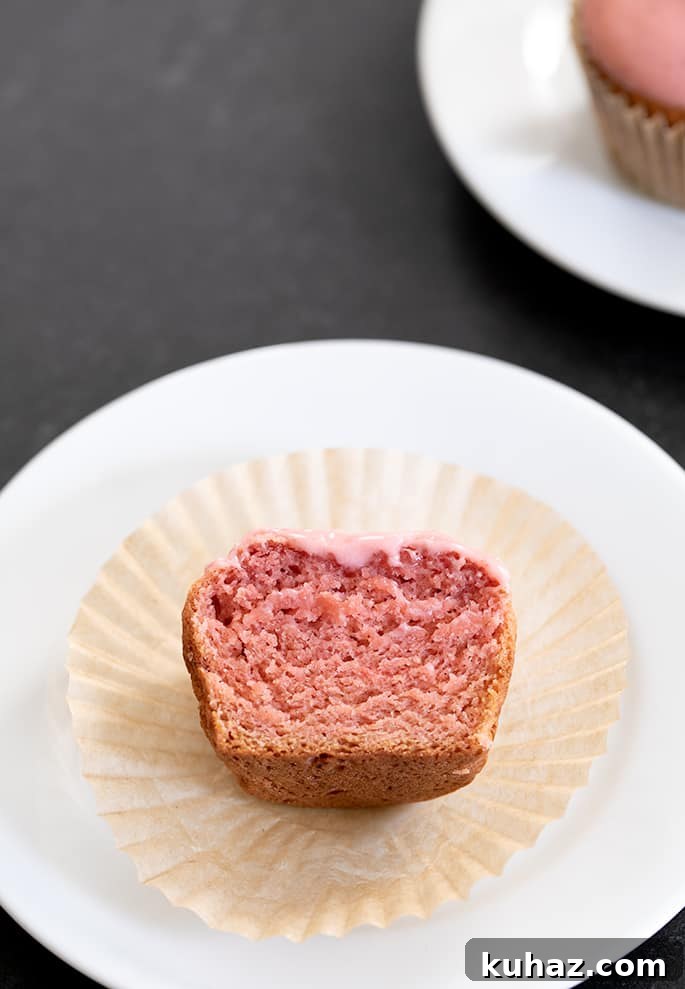 Gluten Free Strawberry Cupcakes with Fresh Strawberry Frosting 6 Strawberry cupcake on a plate cut in half