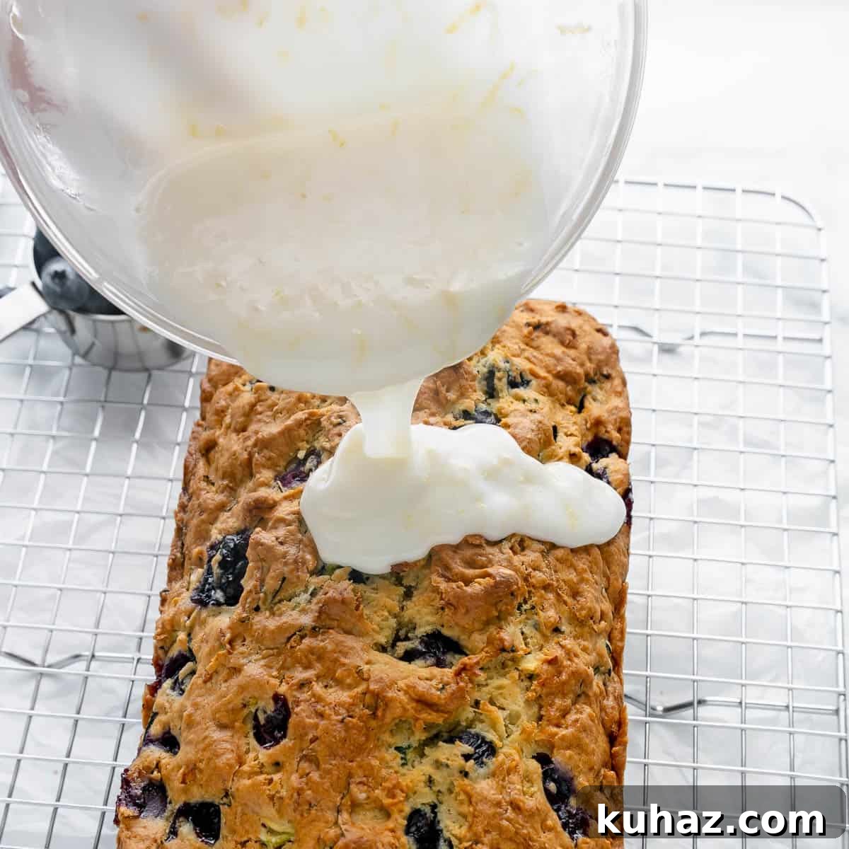 Pouring the glaze on the zucchini bread.