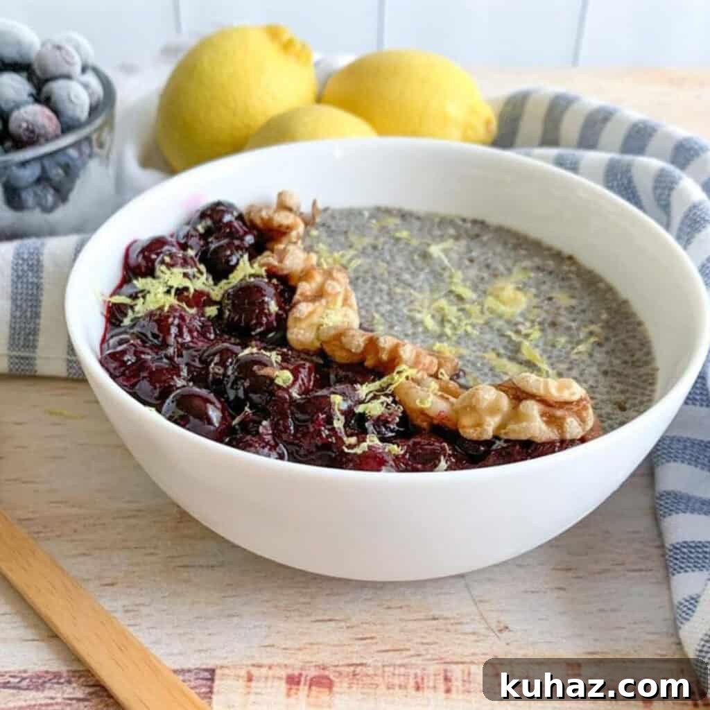 A bowl of chia pudding topped with walnuts, blueberry sauce.