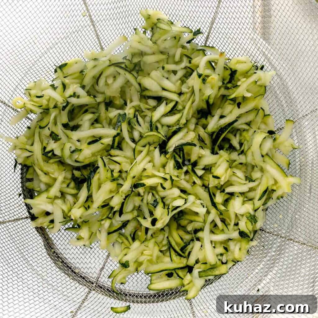 zucchini draining in a strainer.