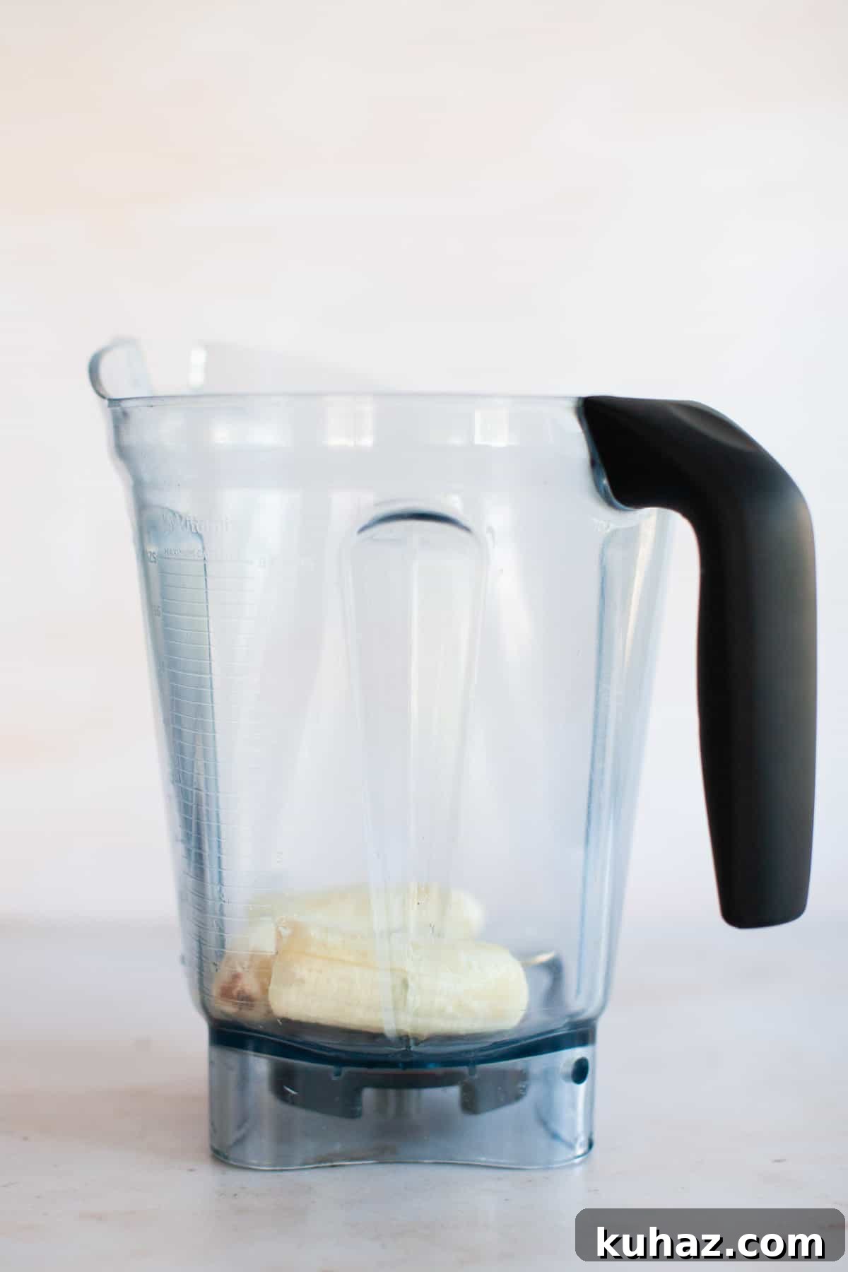Frozen banana in a blender pitcher.