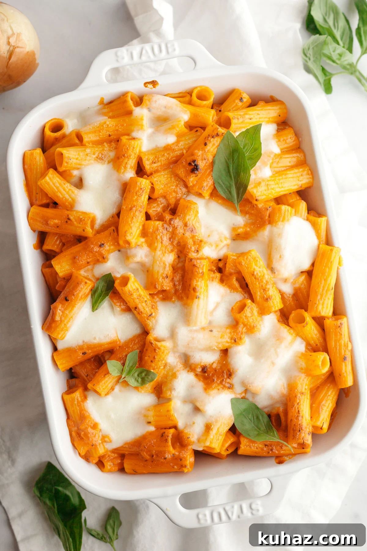 Creamy Baked Pasta with Vodka-Style Sauce, Alcohol-Free 2 Baked vodka pasta in a white dish topped with basil leaves.