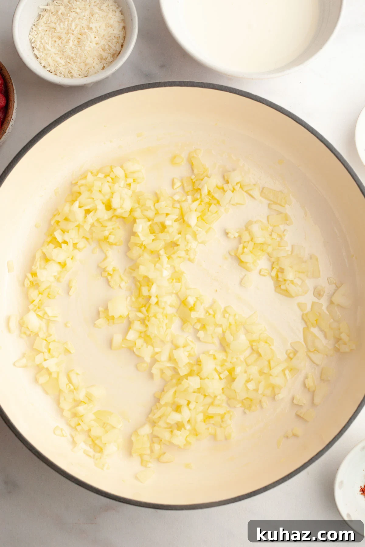 Creamy Baked Pasta with Vodka-Style Sauce, Alcohol-Free 5 Onions frying in a saucepan.