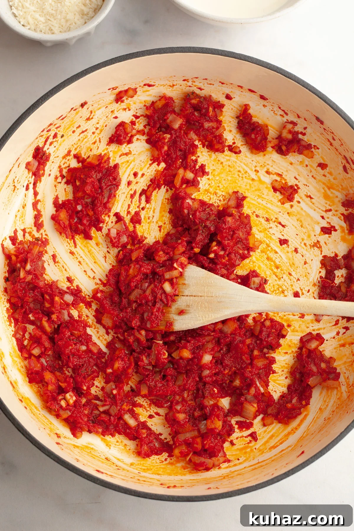 Creamy Baked Pasta with Vodka-Style Sauce, Alcohol-Free 6 A large saucepan with cooked onions and tomato paste.