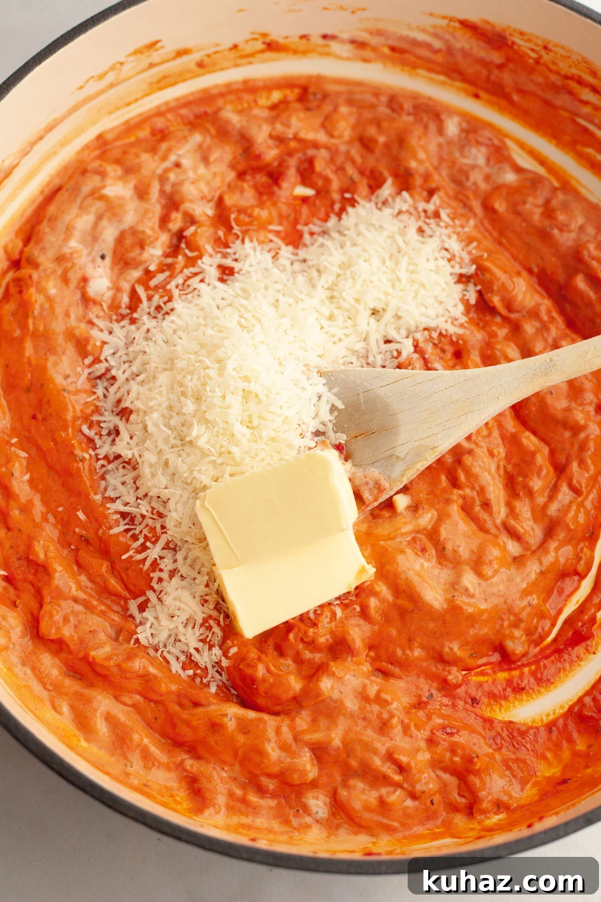 Creamy Baked Pasta with Vodka-Style Sauce, Alcohol-Free 7 Vodka sauce in a large pan with sliced butter and grated parmesan.