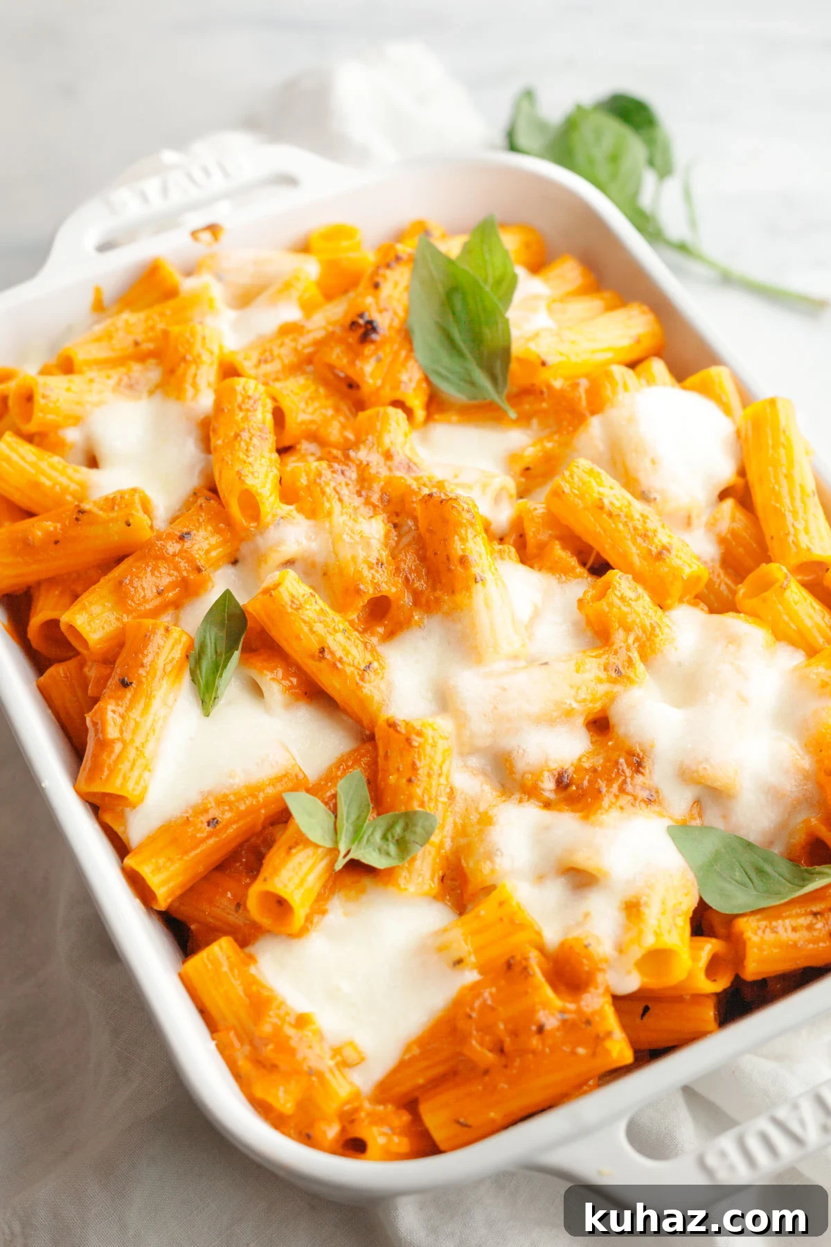 Creamy Baked Pasta with Vodka-Style Sauce, Alcohol-Free 10 Baked vodka pasta in a white dish topped with basil leaves.