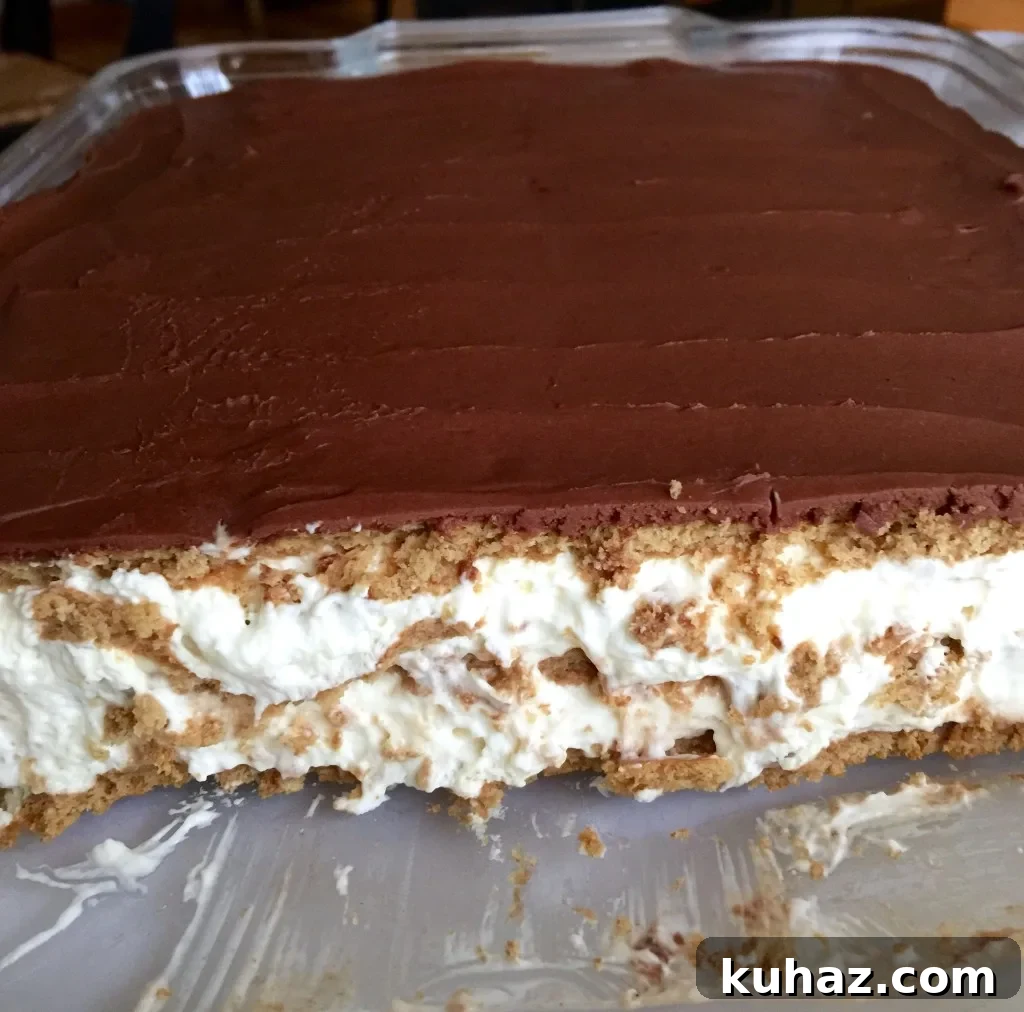 Éclair Cake, in pan, cut to show layers.