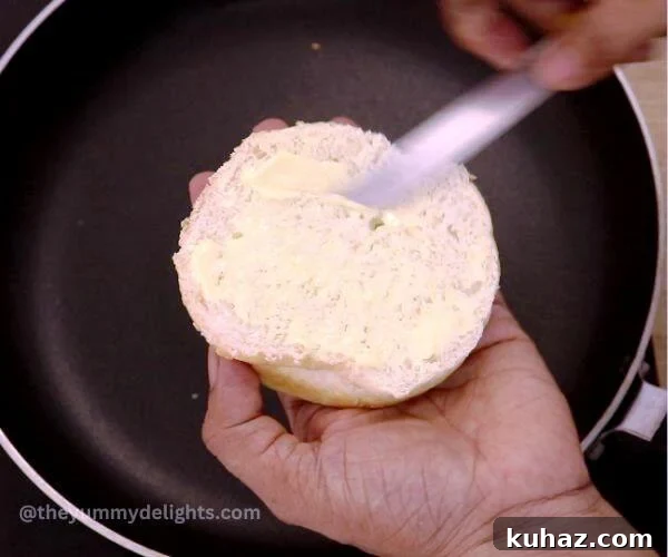 applying butter over bun.