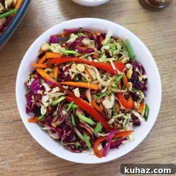 Asian slaw served in a white bowl.