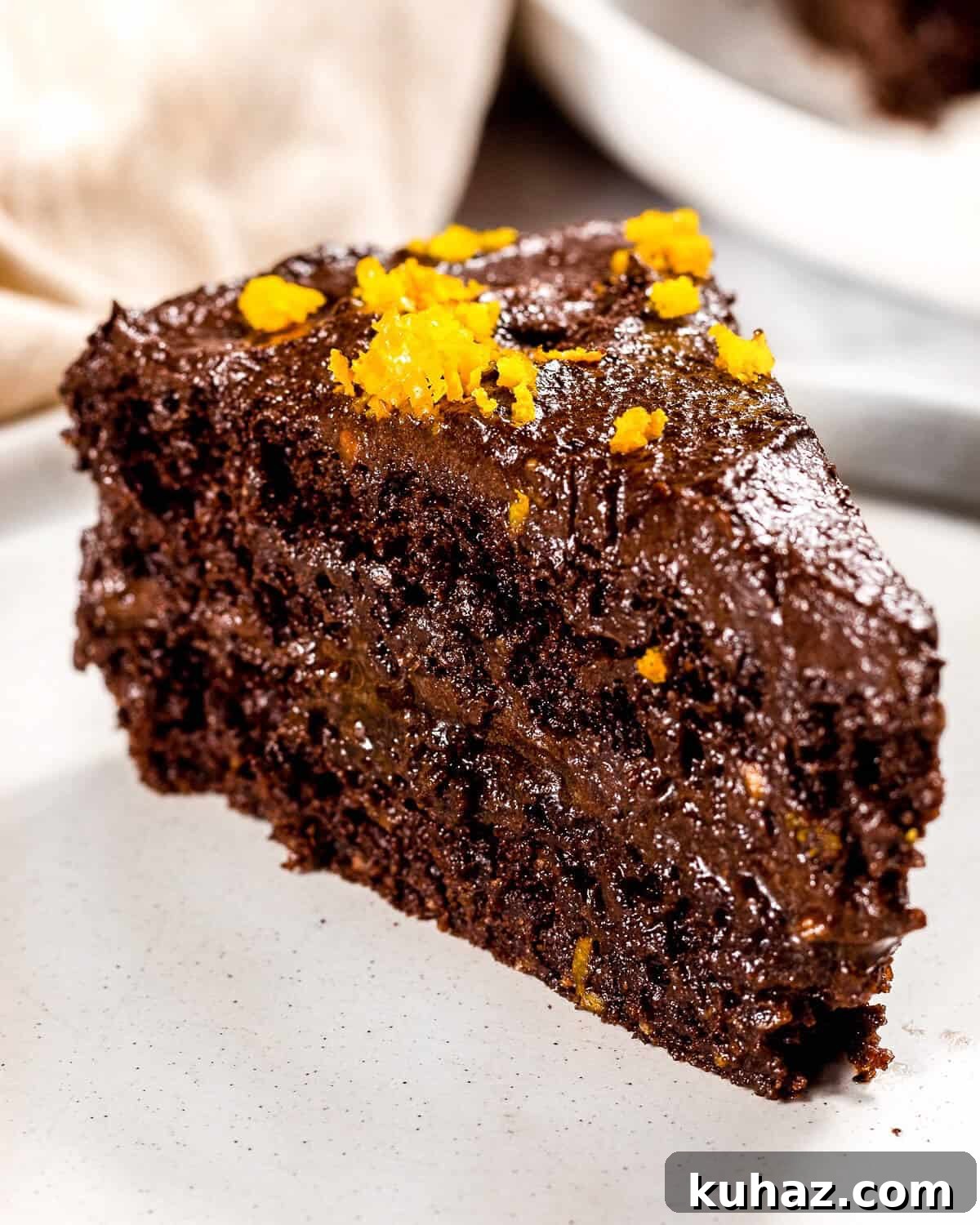 Avocado Chocolate Frosting Recipe — Creamy Dairy-Free 2 A close up image of chocolate orange cake with healthy chocolate frosting.