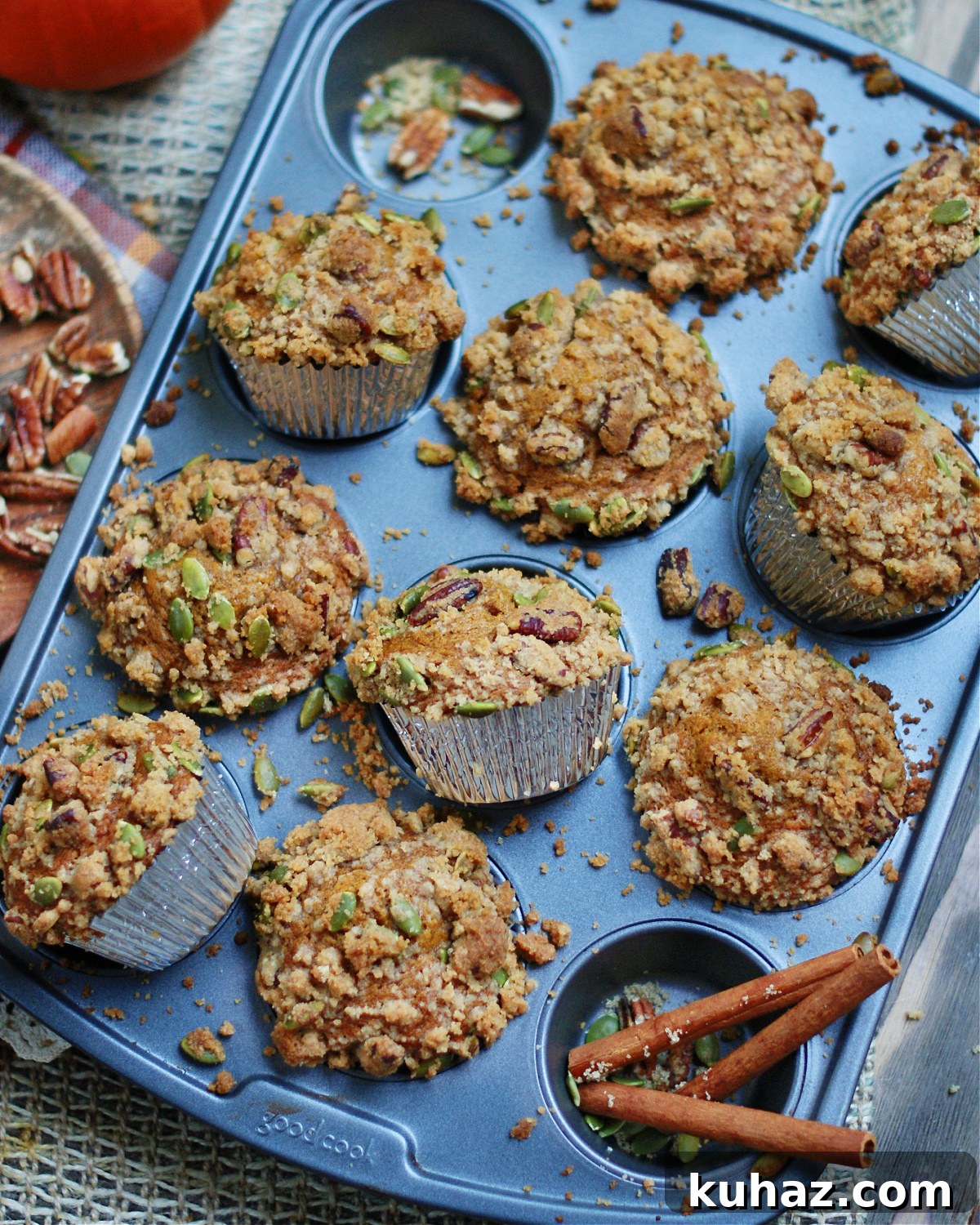 Pumpkin Muffins with Cinnamon Streusel 8 A muffin tin full of baked pumpkin muffins with cinnamon and brown sugar streusel topping