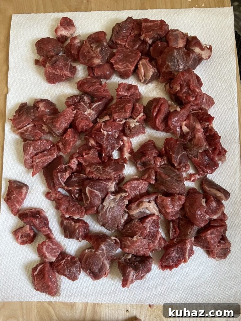 Italian Beef and Potato Soup - Nonna Pot-Roast 5 Bite-sized pieces of chuck roast patted dry and ready to coat with flour for Italian beef soup.