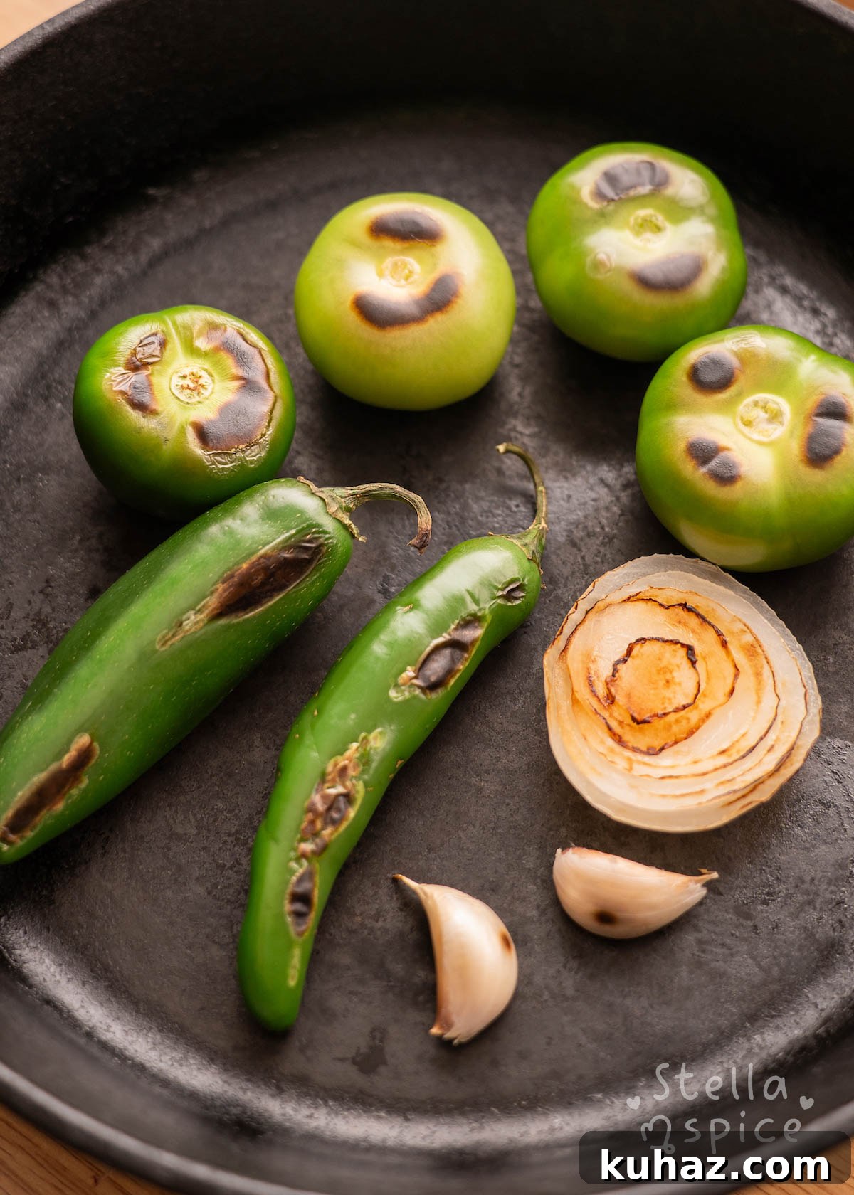 tomatillos, garlic, onion, and serrano peppers charred in a skillet