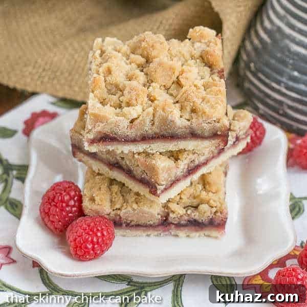 Raspberry Crumb Bars Simple, but delectable bars with a layer of raspberry jam and a thick crumb topping!