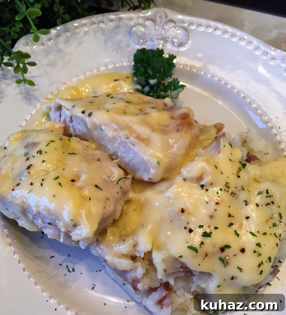 Slow Cooker Chicken Fried Country Pork Chops 2 Chicken Fried Pork Chops in the Slow Cooker served over a plate of mashed potatoes.