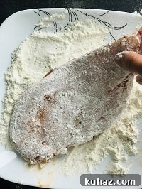 dredging chicken breast with flour