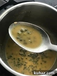 piccata sauce in a ladle
