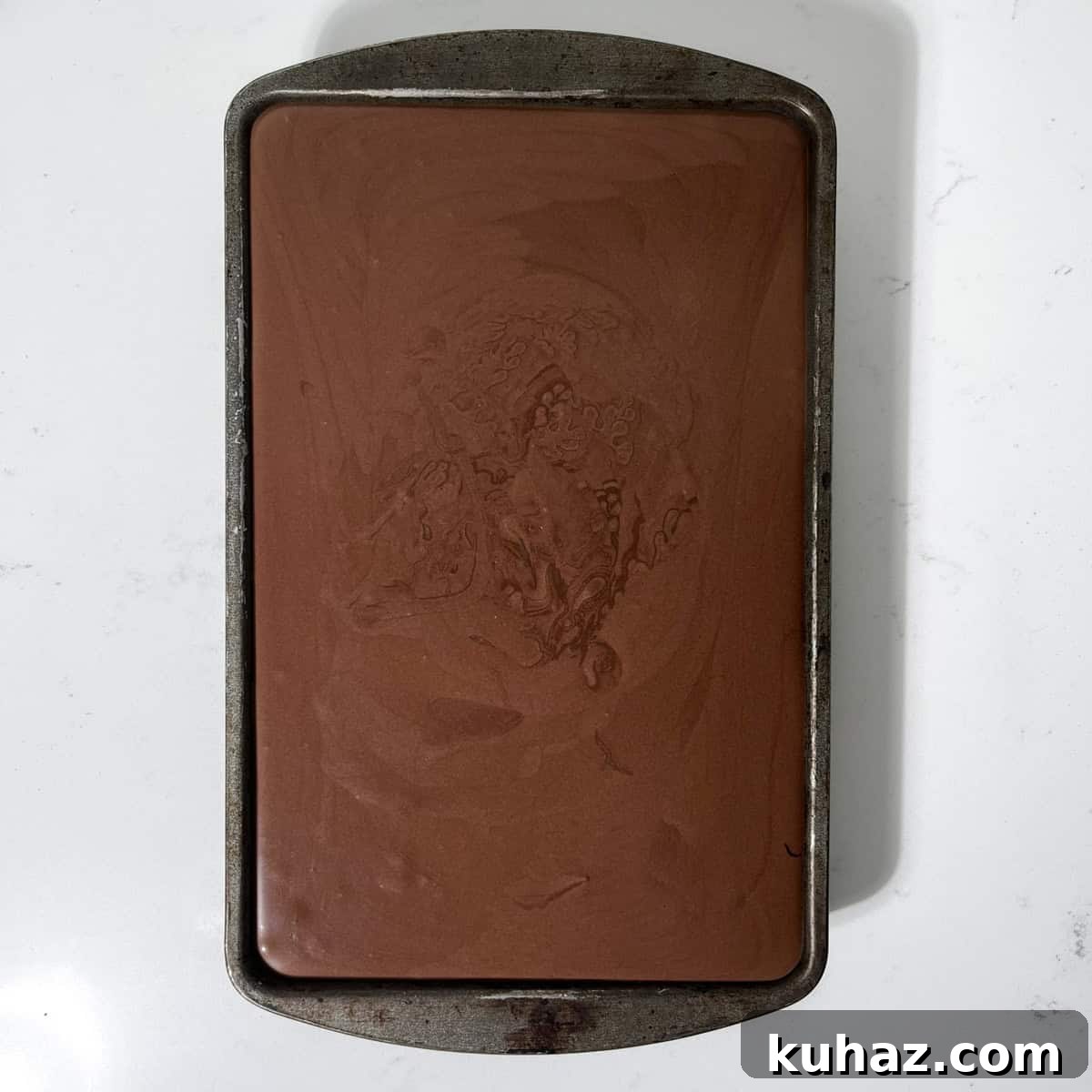 No-Churn Dark Chocolate Ice Cream Recipe 10 Dark chocolate ice cream in a baking tray.