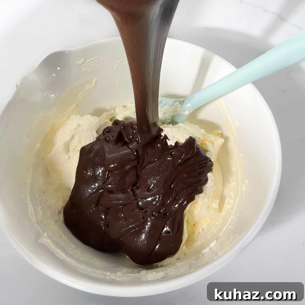 No-Churn Dark Chocolate Ice Cream Recipe 8 Adding melted chocolate mixture to the whipped cream for the dark chocolate ice cream.