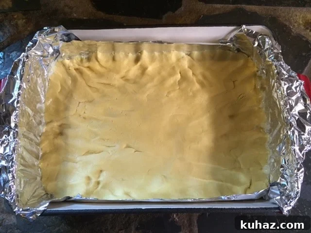 Vintage Chess-Themed Bars for Classic Game Nights 5 The crust patted into the bottom of the 9x13 pan