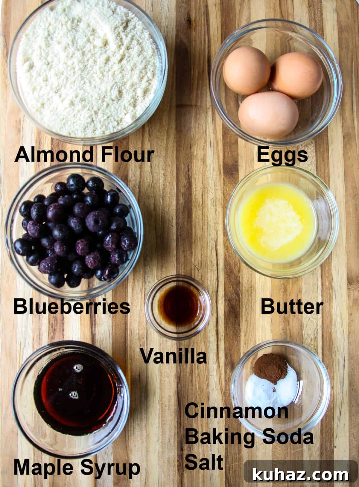 Almond Flour Blueberry Muffins, Tender and Fluffy 4 The ingredients for making this recipe in glass bowls on a wooden board.