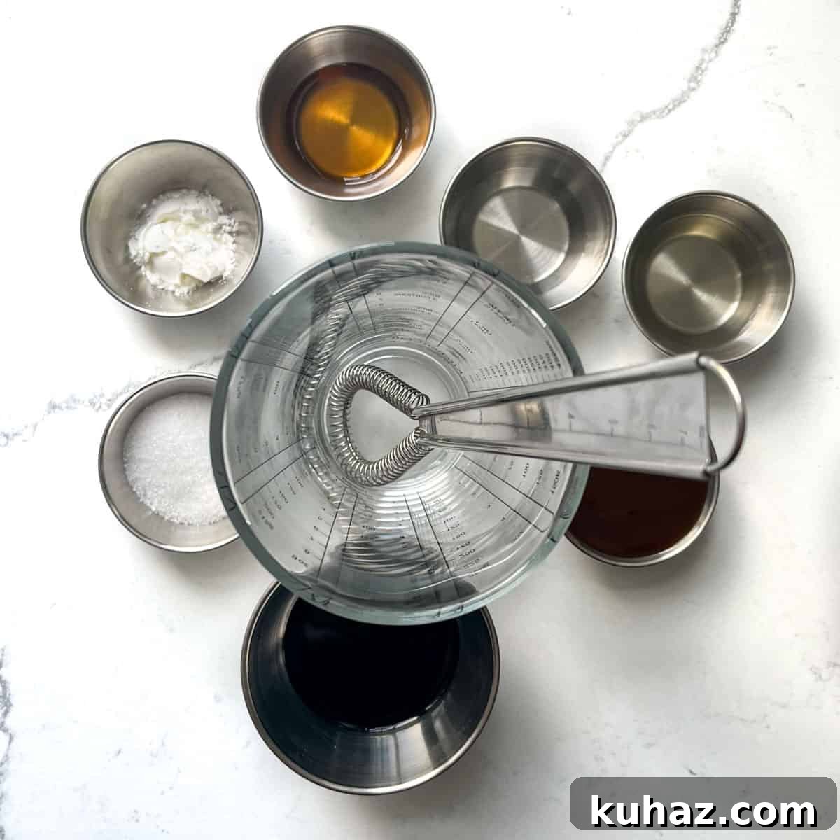 Yuk sung sauce ingredients around an empty measuring jug.