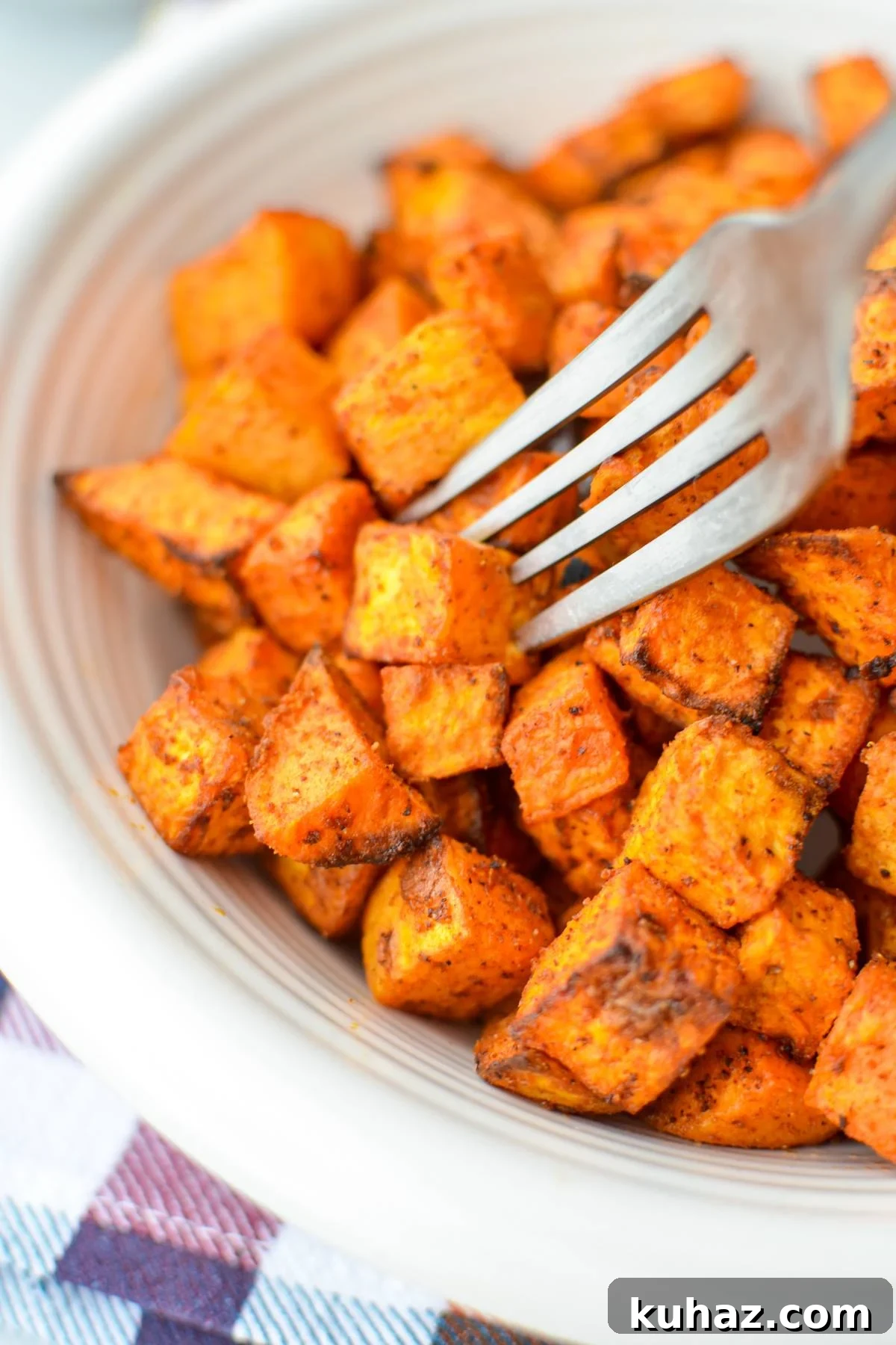 Crispy Air Fryer Sweet Potato Cubes 10 A fork piercing into a sweet potato cube.