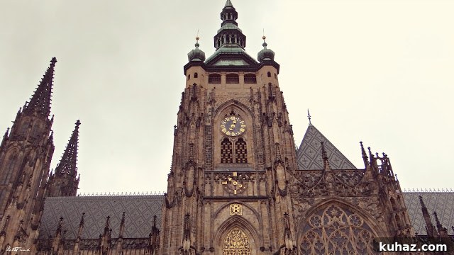 A large clock tower in front of a building