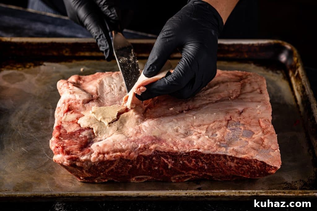 Smoked Beef Ribs Recipe: Fall-Off-the-Bone BBQ 3 Beef rib membrane being pulled off the ribs.