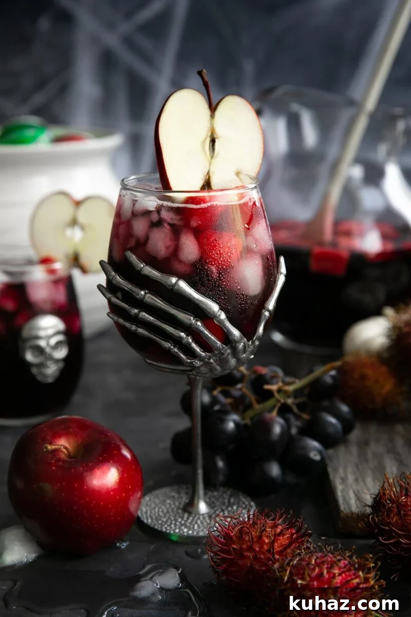 Black Magic Halloween sangria with red wine, vodka, fruit, and soda.