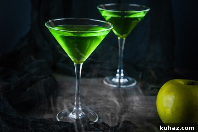 Green poison apple cocktail for an adult Halloween party.