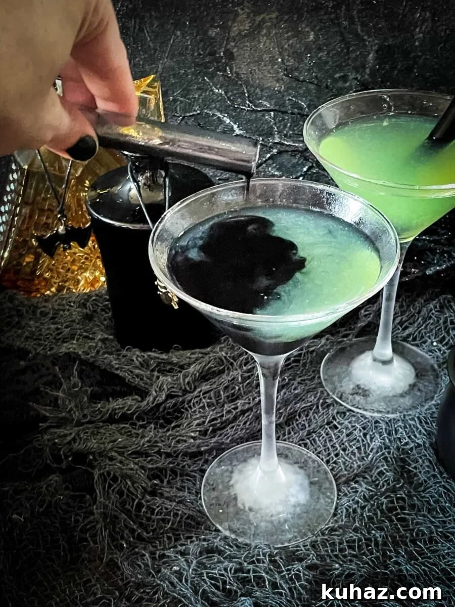 Poison apple Halloween cocktail with rum, sour apple, and cinnamon schnapps.