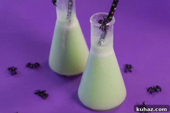 Halloween spiked toxic tonic served in beakers with a green color.