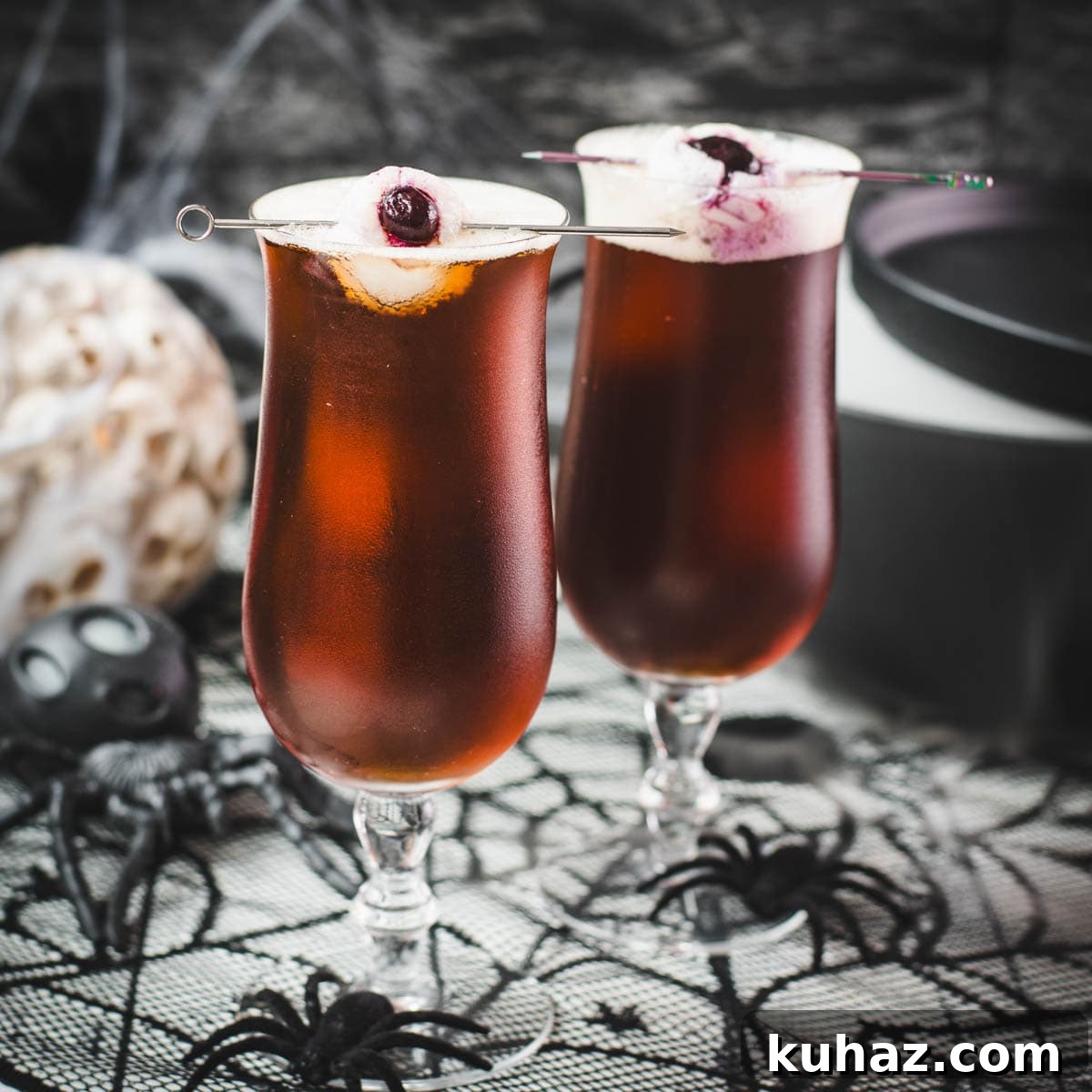 Black Velvet Halloween drink garnished with eerie lychee eyeballs.