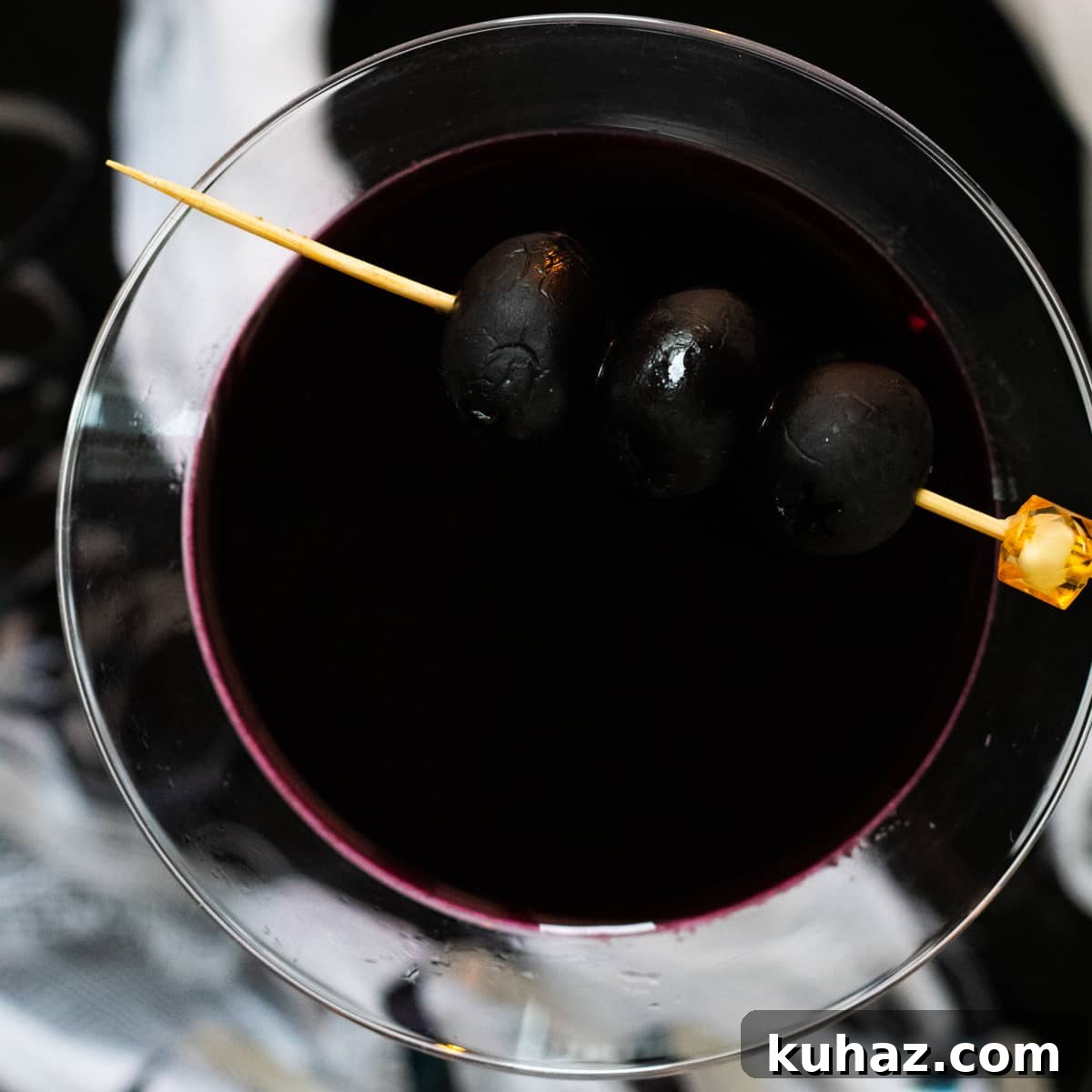 Black Widow Martini Mocktail made with black olive brine, beet juice, and lemon.