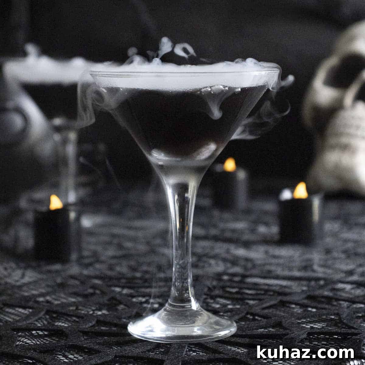 Spooky black vodka witches martini for a Halloween party.