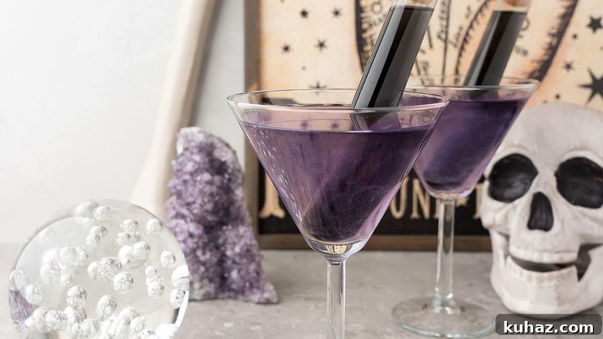 Black Magic rum Halloween cocktail with grape schnapps and strawberry rum.