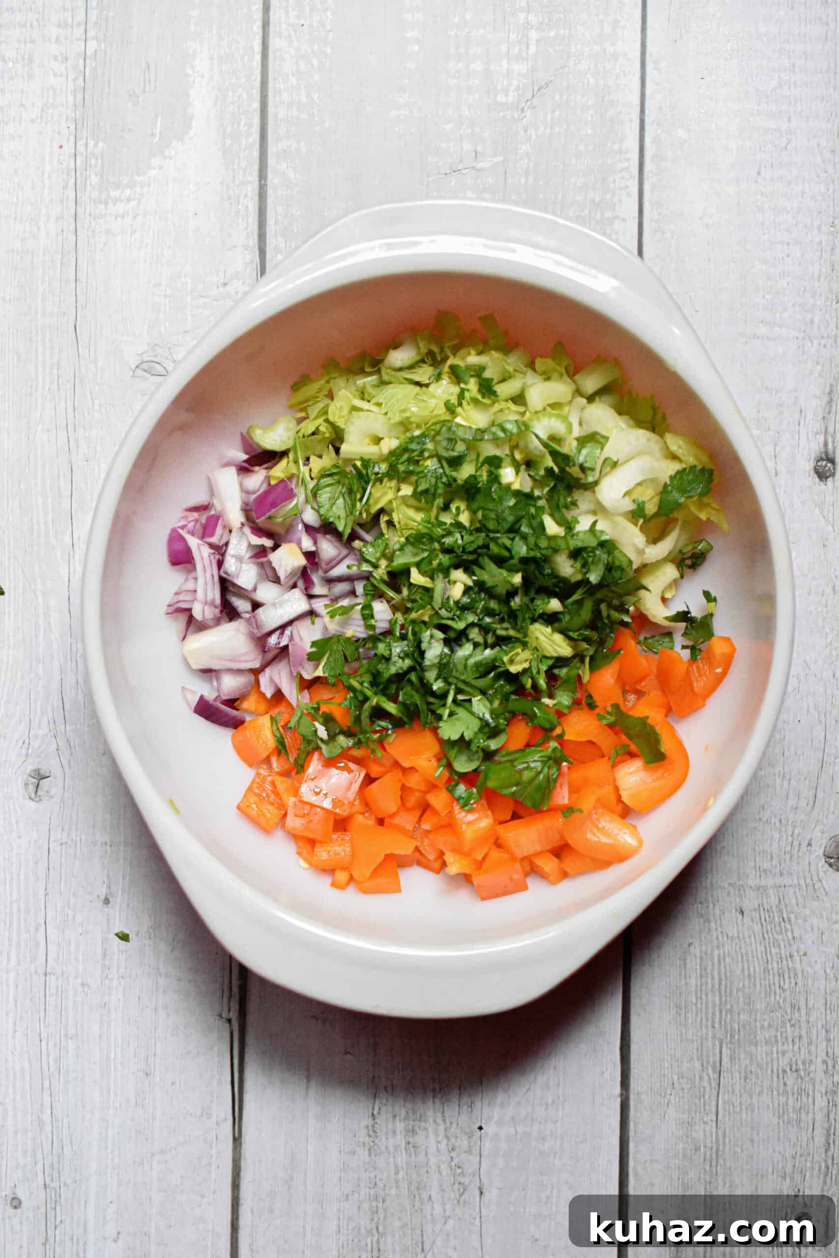 The fresh herbs are added to the bowl